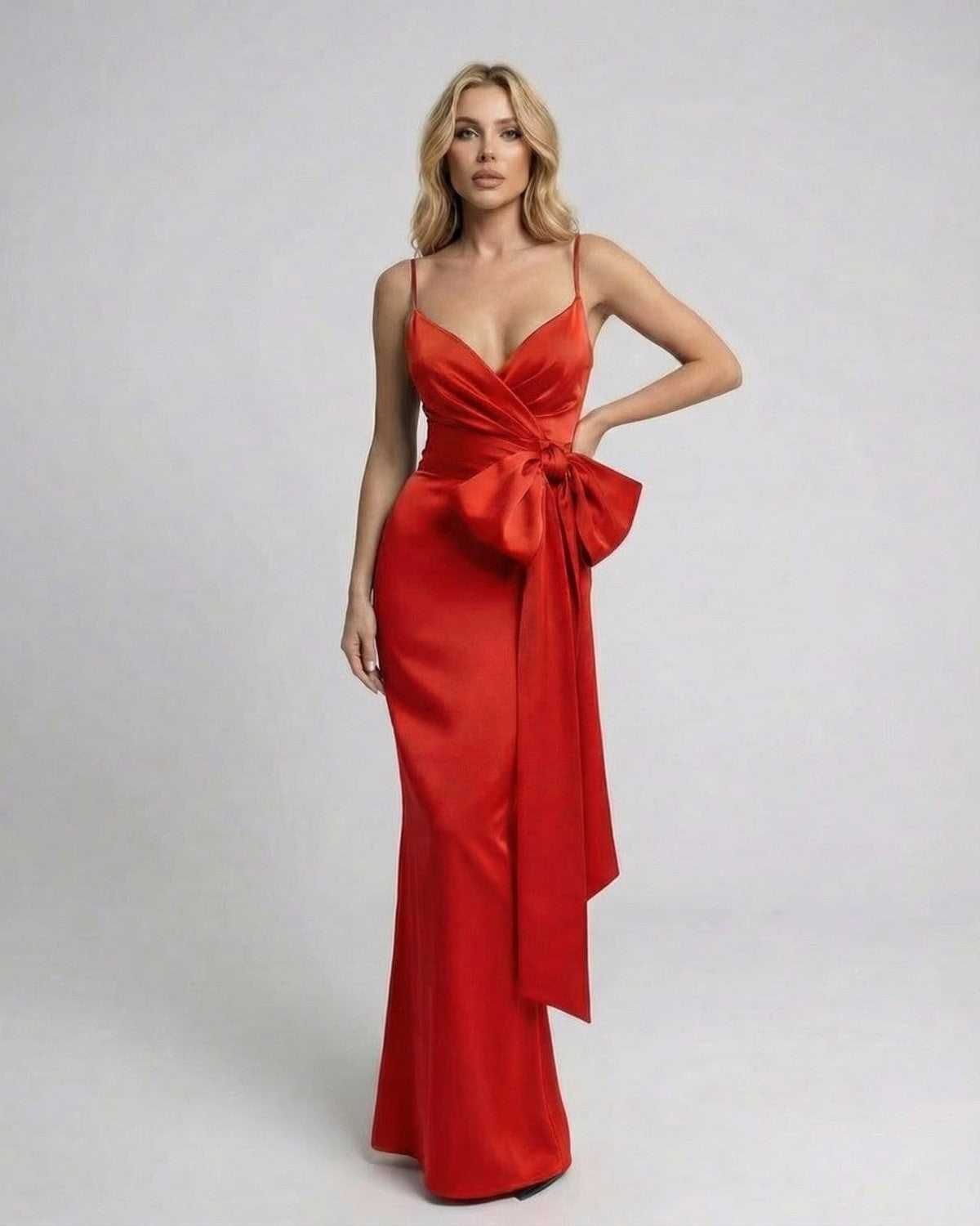 Valencia Maxi Dress by Lauven, featuring an asymmetrical design and oversized side bow in a vibrant red finish.