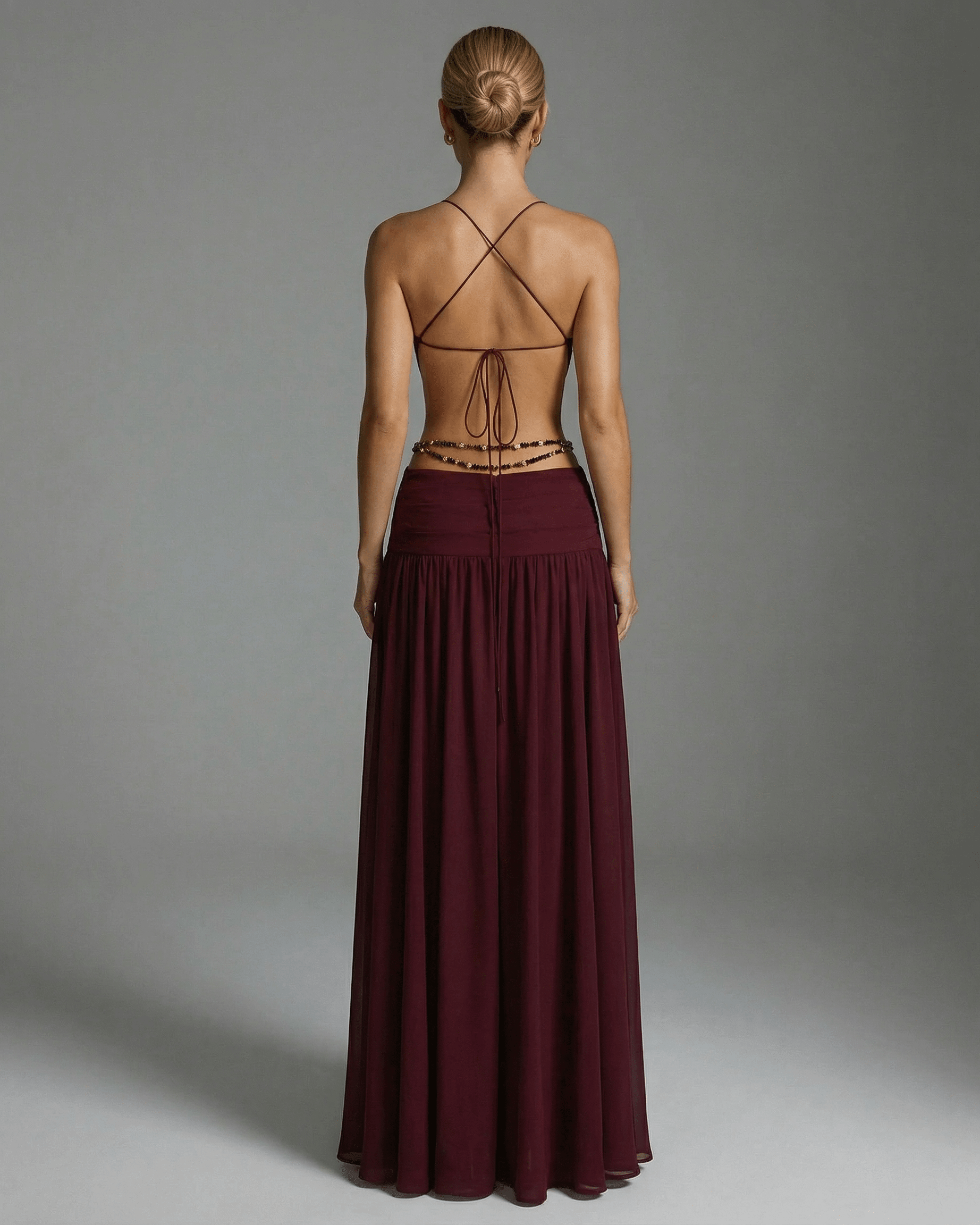 Back view of the Valencia Maxi Dress by Lauven, featuring a burgundy color and an elegant open back design.