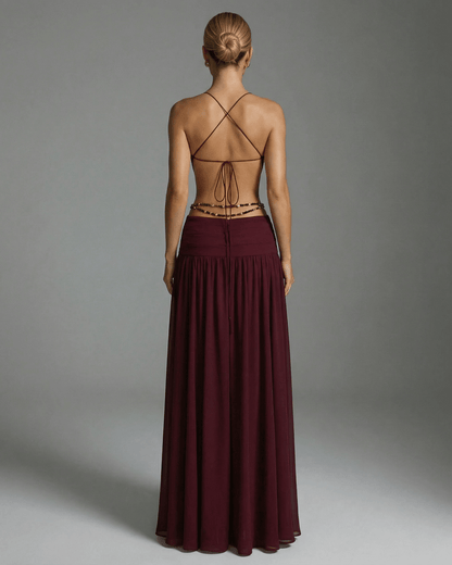 Back view of the Valencia Maxi Dress by Lauven, featuring a burgundy color and an elegant open back design.