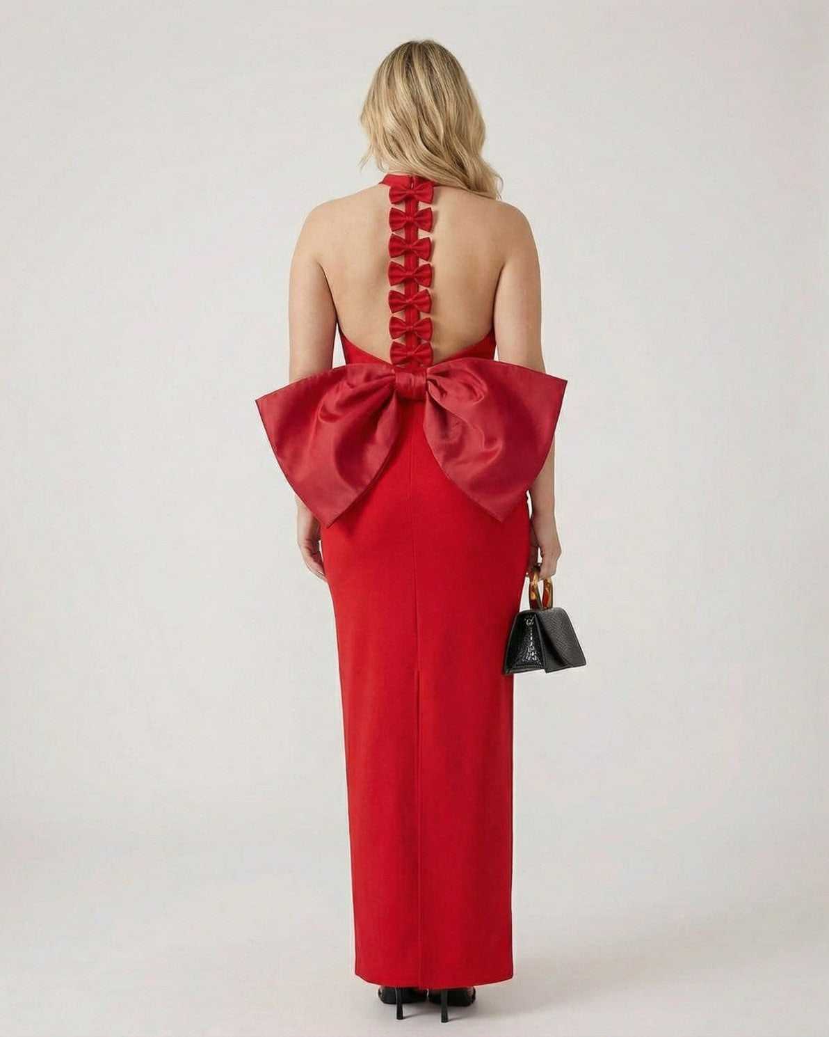 Valencia Maxi Dress by Lauven in red with a halter neck and statement bow detail at the back.