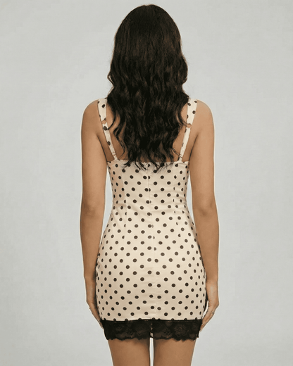 Valencia Mini Dress by Lauven, showcasing polka dot design and lace trim from the back view.