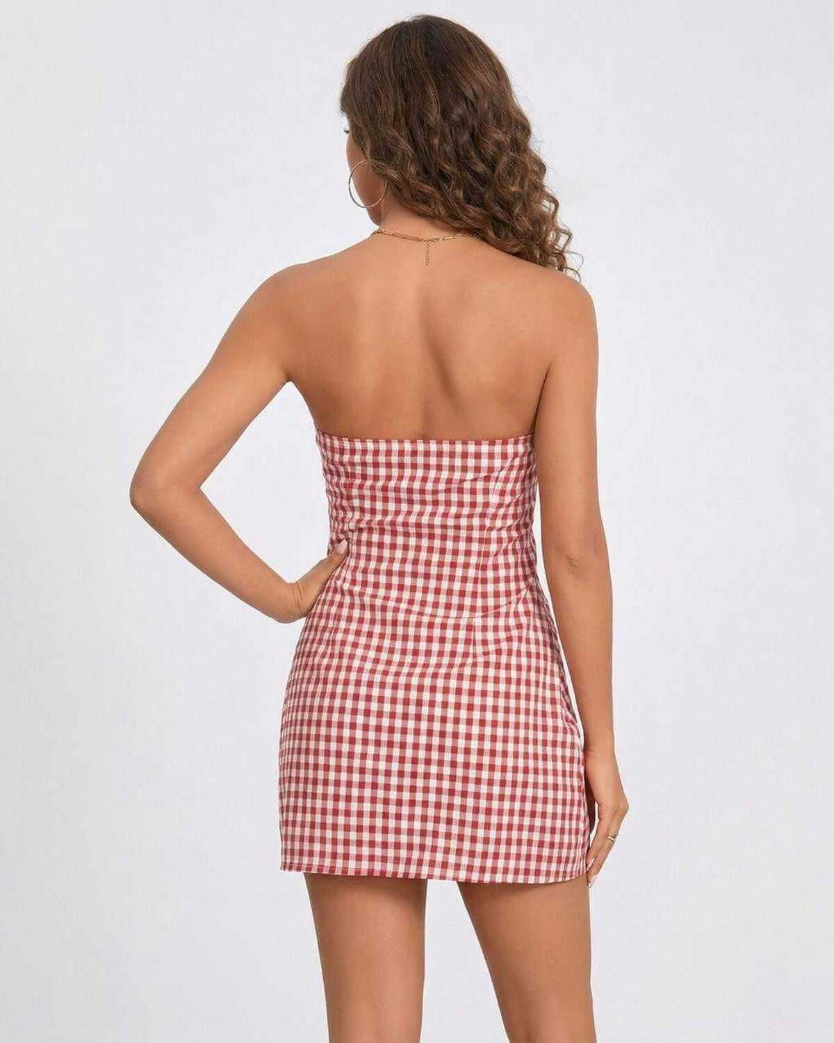 Back view of a model wearing the Valencia Mini Dress by Lauven, showcasing the strapless design and gingham pattern.