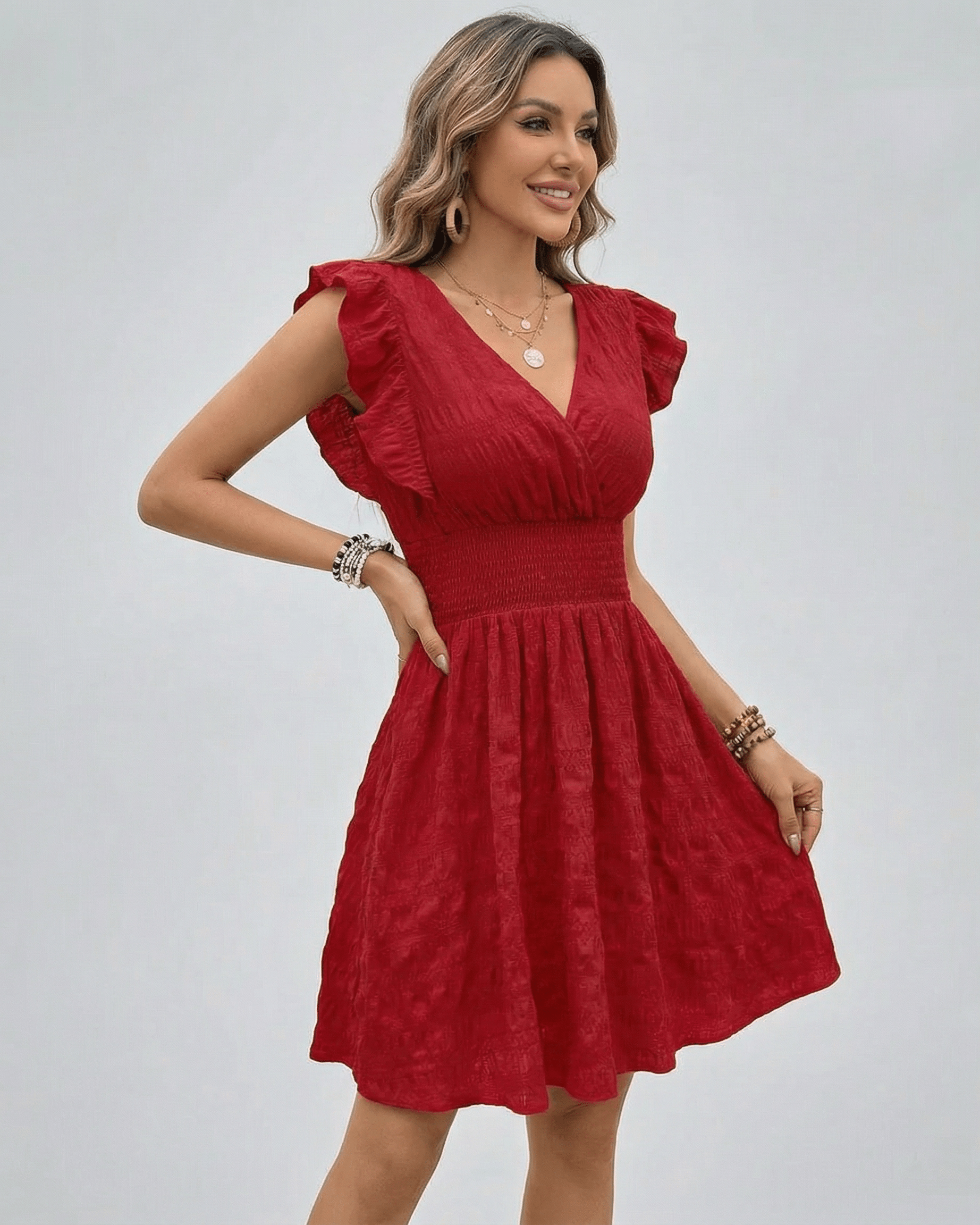 Valencia Mini Dress by Lauven in red with V-neck and smocked waist, perfect for versatile seasonal wear.