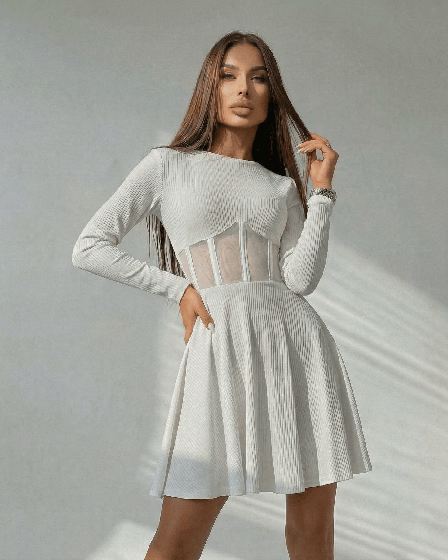 Valencia Mini Dress by Lauven, featuring a white long sleeve A-line design and sheer corset panel for a stylish look.