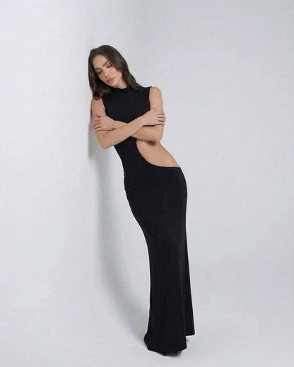 Model wearing Lauven Vega Maxi Dress, a high stretch knitted sleeveless black maxi dress with cutout design.