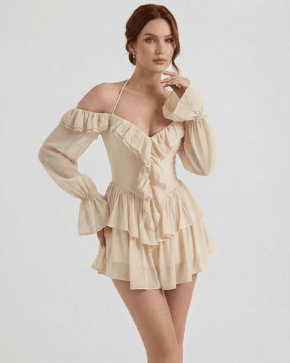 Velina Mini Dress by Lauven – Beige Ruffle Halter Mini Dress with Sheer Sleeves and flowing silhouette.