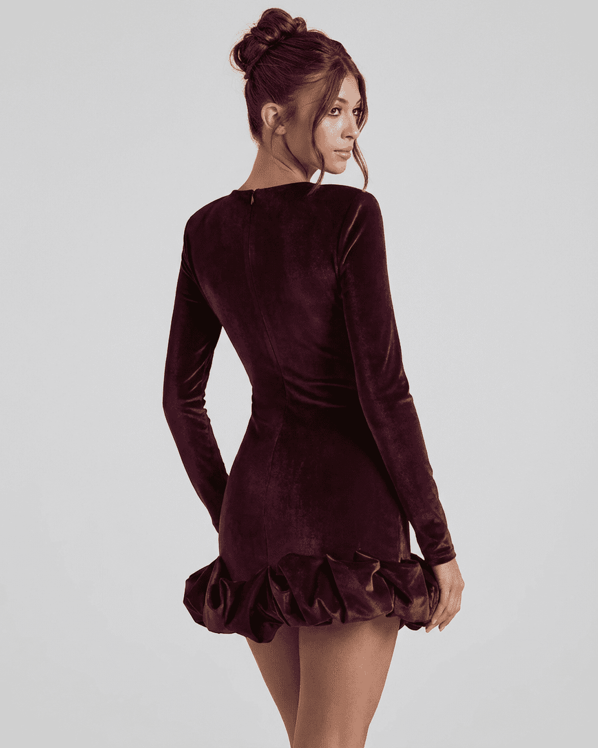 Velora Mini Dress by Lauven, showcasing a deep burgundy velvet bodycon style with a pleated hem.
