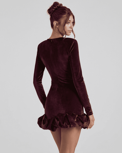 Velora Mini Dress by Lauven, showcasing a deep burgundy velvet bodycon style with a pleated hem.