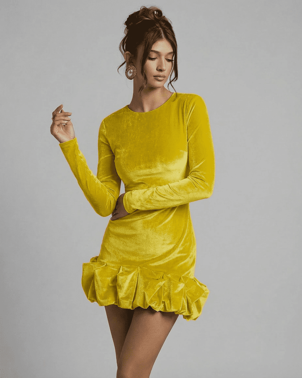 Model wearing the Velora Mini Yellow dress by Lauven, showcasing luxe velvet fabric and a pleated hem.
