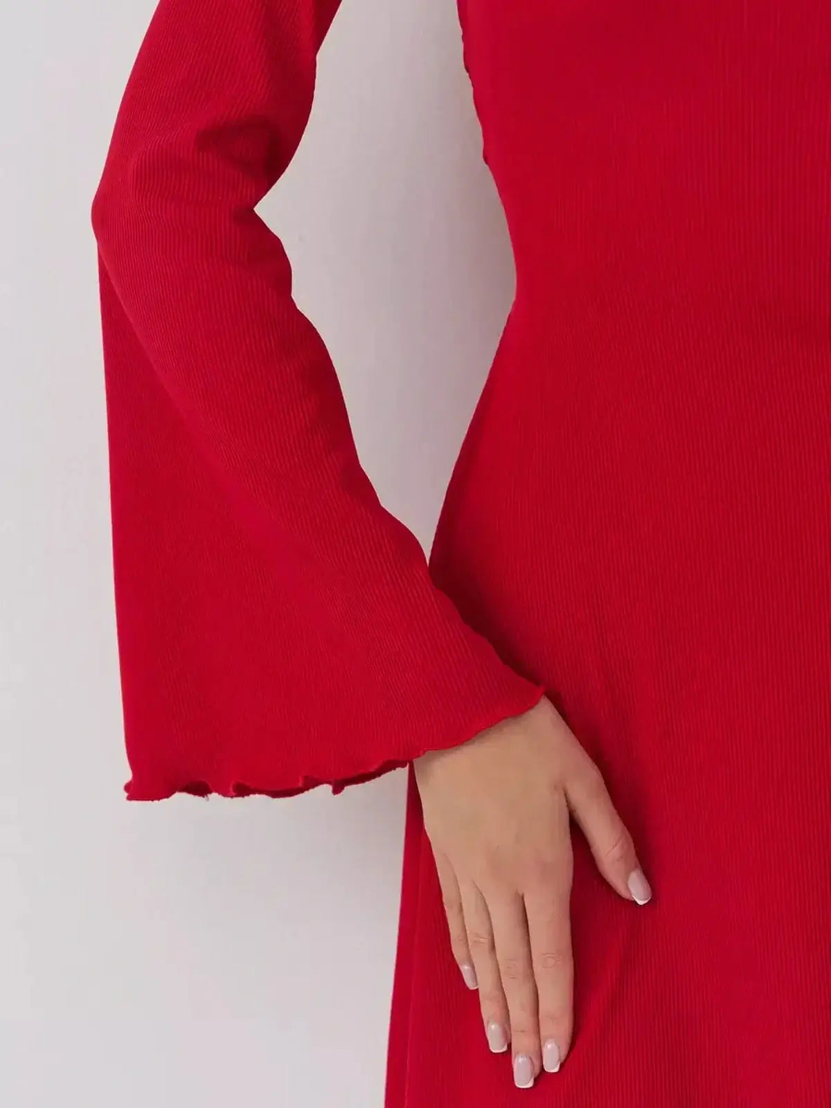 Detail of Velvet Flame red dress by Lauven showcasing the elegant bell sleeve design.