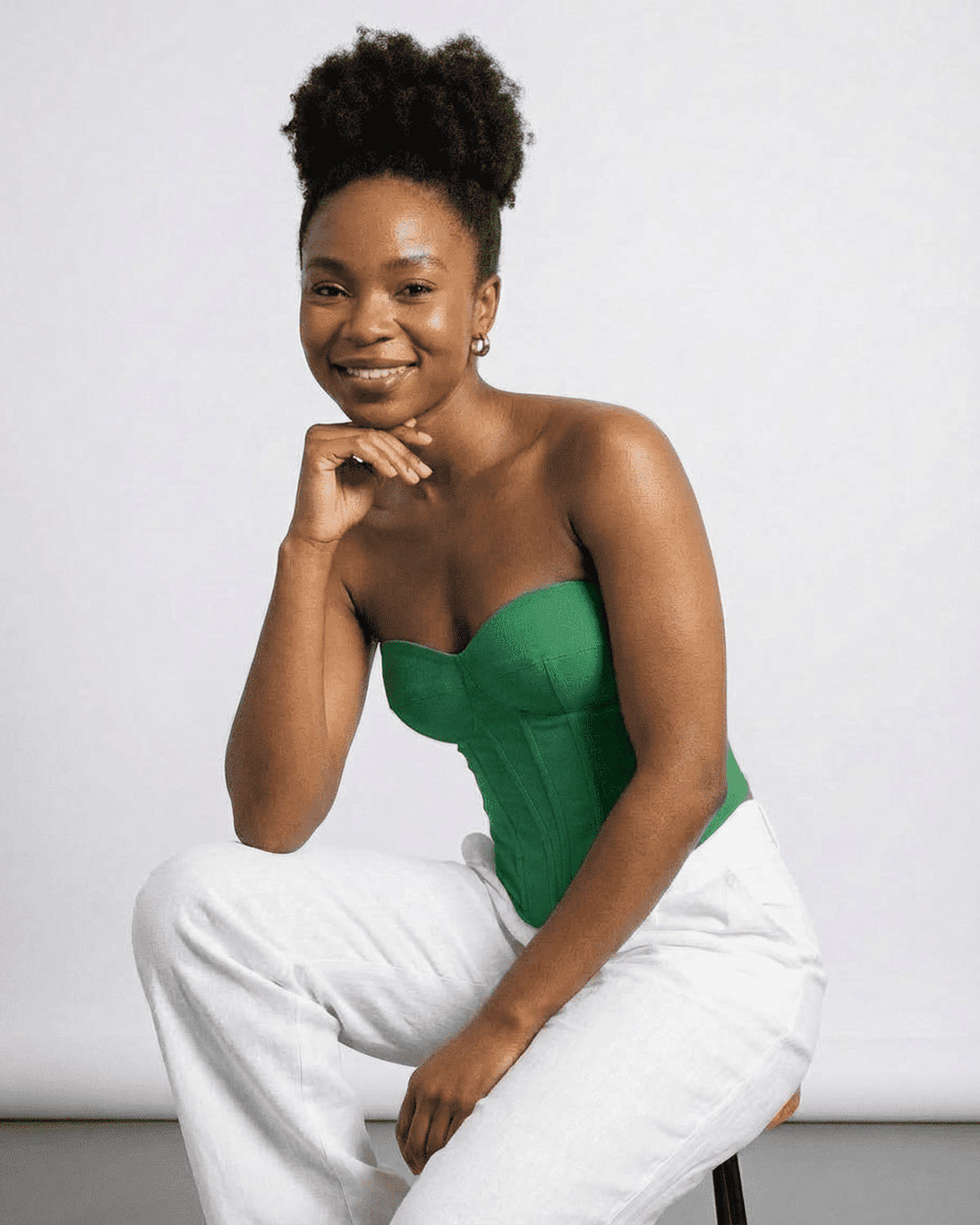 Model wearing Verde Corset Top by Lauven, showcasing its green faux denim style and structured design.