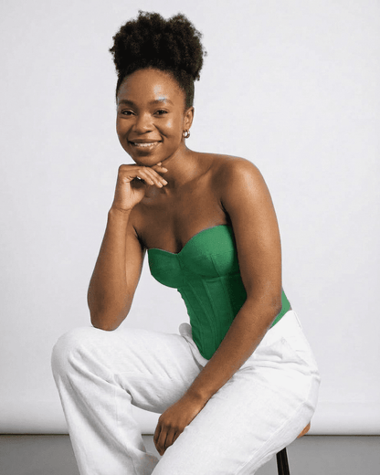 Model wearing Verde Corset Top by Lauven, showcasing its green faux denim style and structured design.