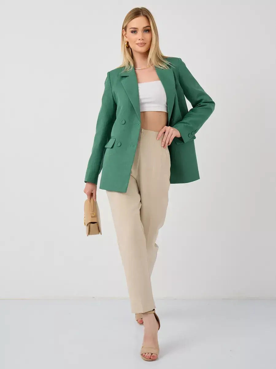 Model wearing Verde Blazer by Lauven, an oversized double-breasted green tailored jacket with beige pants.