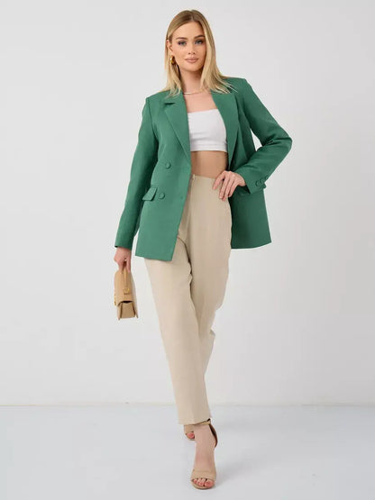 Model wearing Verde Blazer by Lauven, an oversized double-breasted green tailored jacket with beige pants.