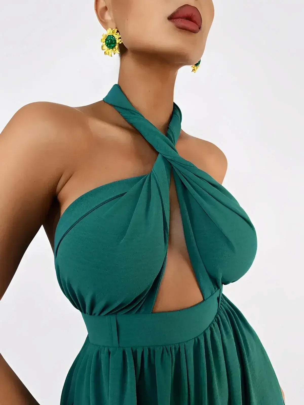 Close-up of Verona Jumpsuit by Lauven, featuring twisted halter neckline and rich emerald fabric.