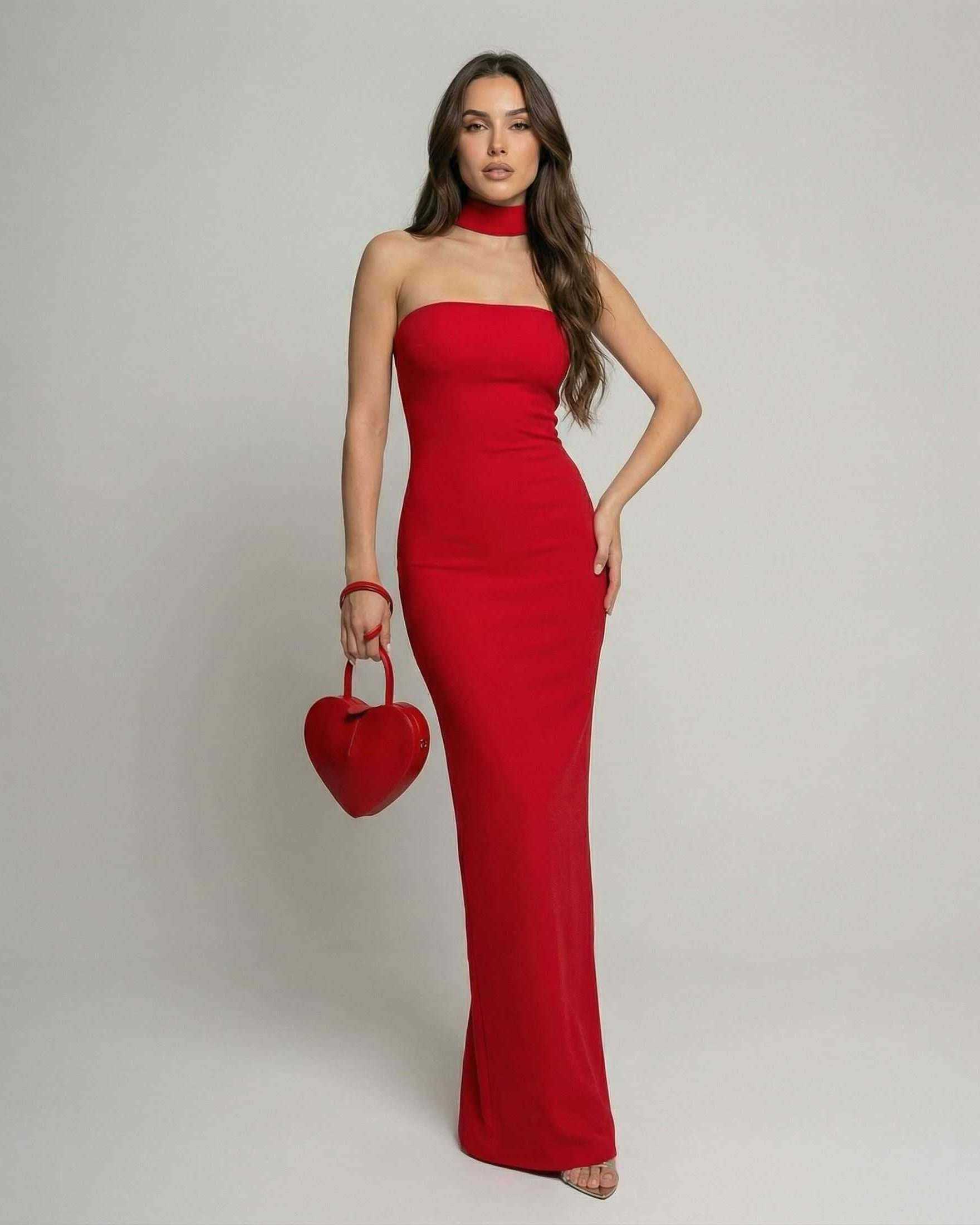 Verona Maxi Dress by Lauven – Red Halter Neck Bandage Sheath Silhouette in a sleek fit with a heart-shaped handbag.