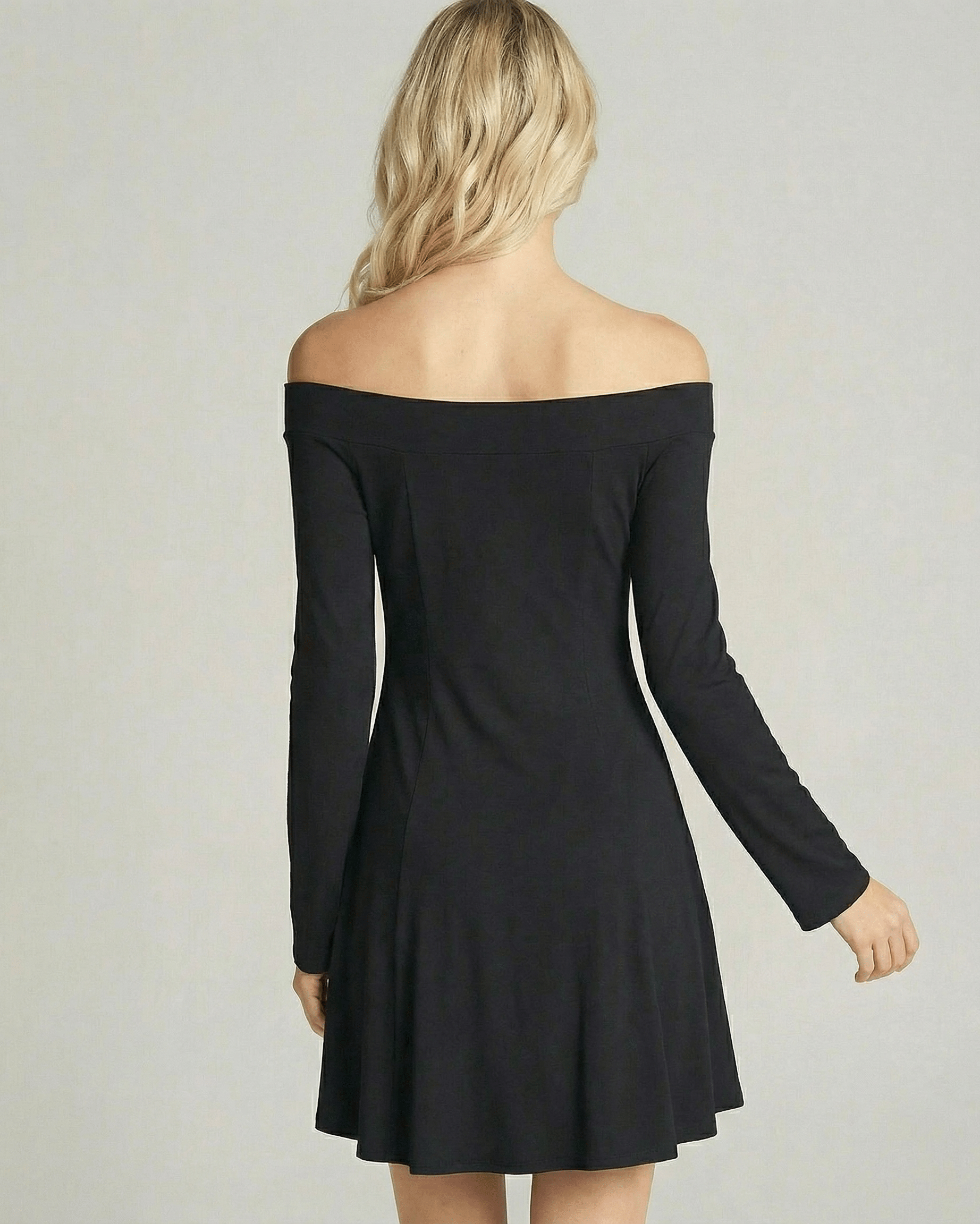 Back view of a model wearing the Lauven Verona Mini Dress, featuring an off-shoulder neckline and A-line silhouette.