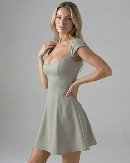 Lauven Verona Mini Dress in soft green, showcasing a panelled bodycon design with short sleeves and a flattering silhouette.