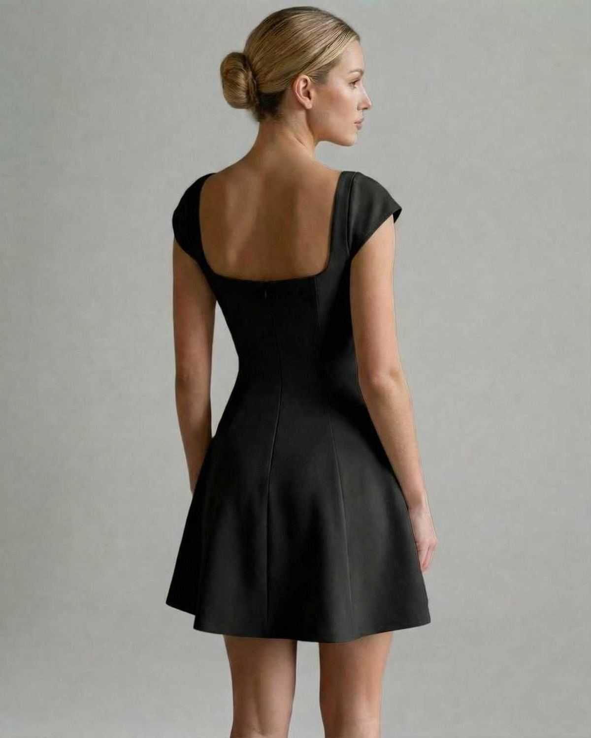 Verona Mini Dress by Lauven showing a back view of a structured black mini dress with short sleeves.