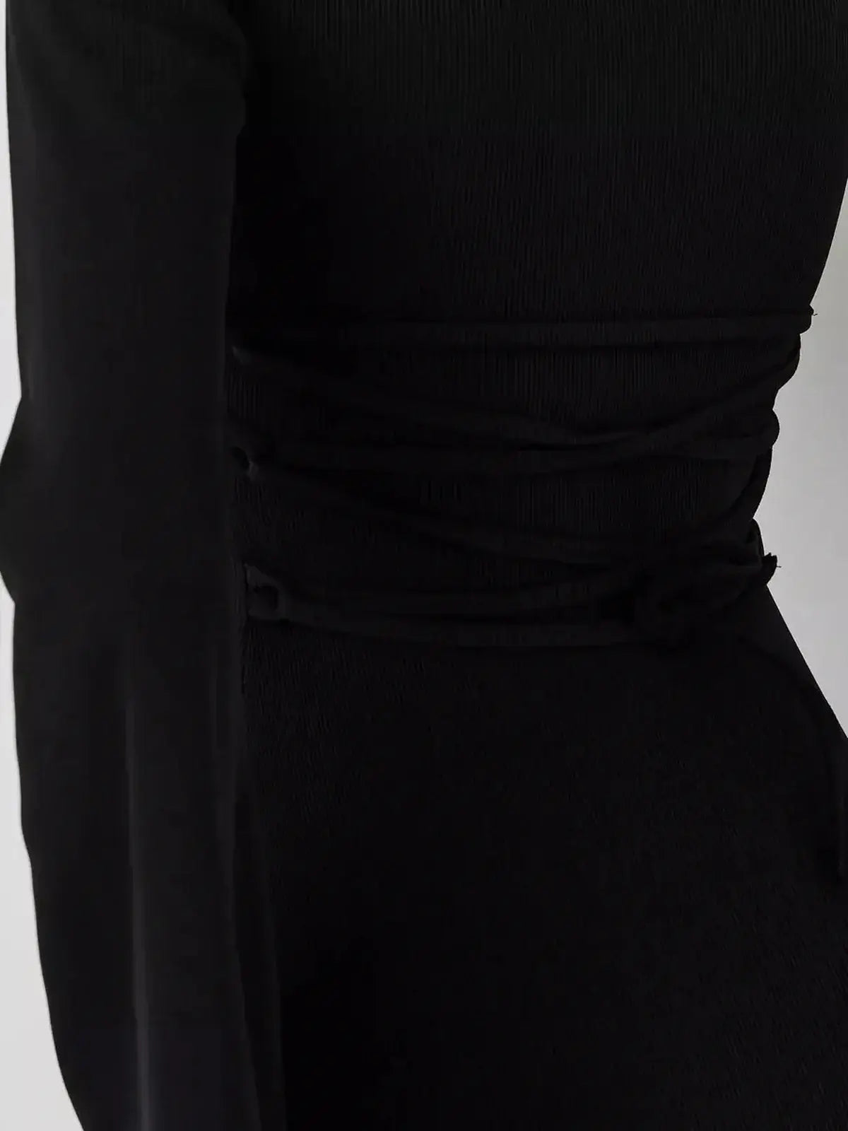 Velvet Hour mini dress detail featuring luxurious ribbed knit, structured U-neckline, and flared cuffs by Lauven.