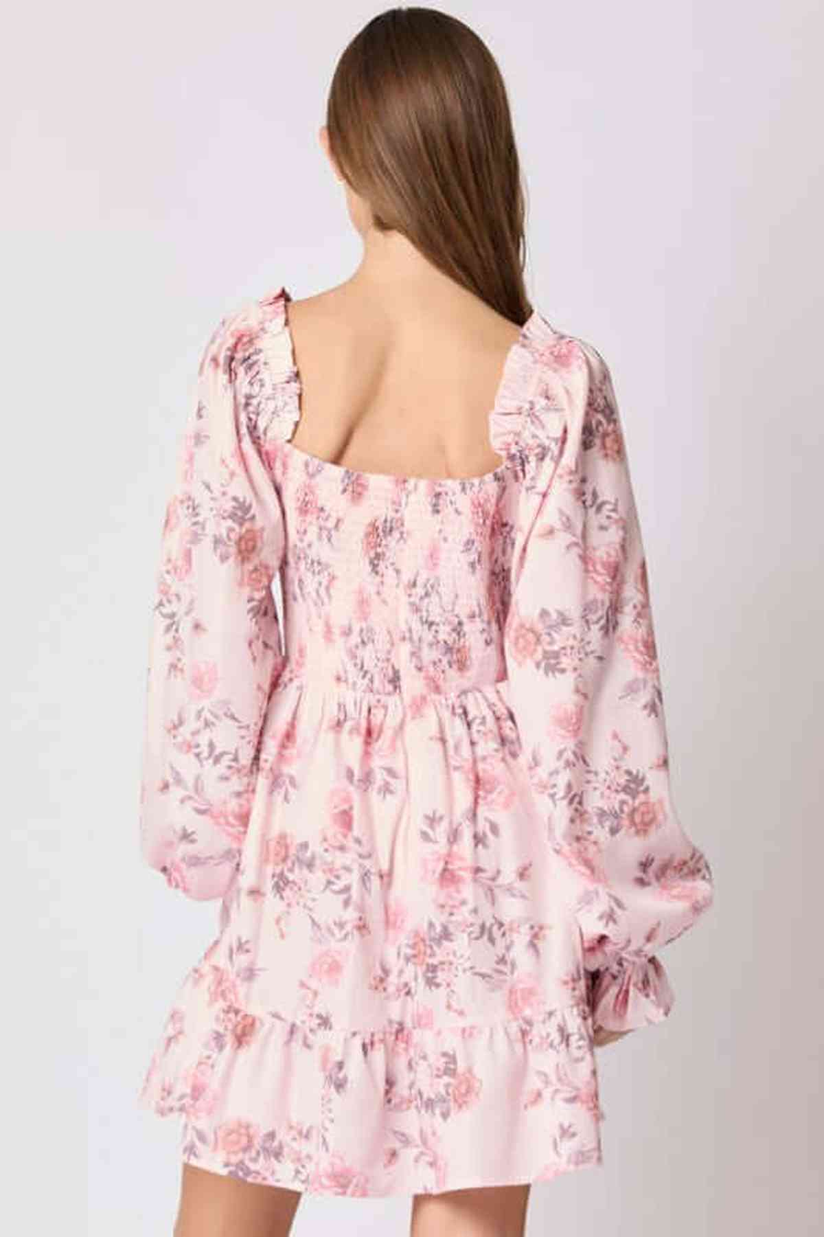 Back view of Lila Mini Dress featuring floral print, bow accents, and puff sleeves, perfect for summer and weddings.