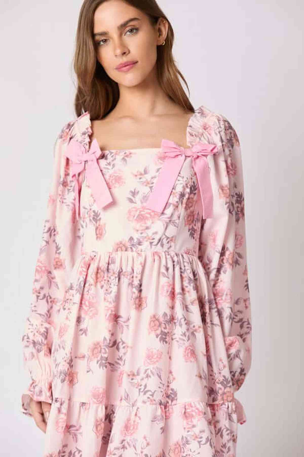 Lila Mini Dress featuring floral print and pink bow accents, perfect for summer weddings and casual outings.