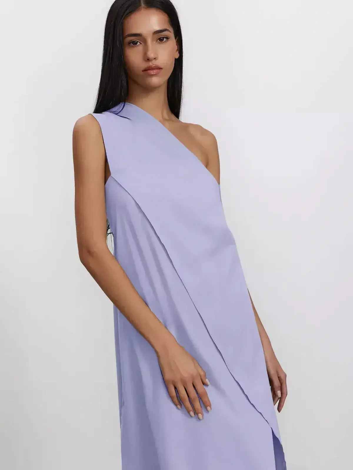 Model showcasing the Lilac Flow Maxi Dress featuring one-shoulder design and soft draping in a pastel hue.