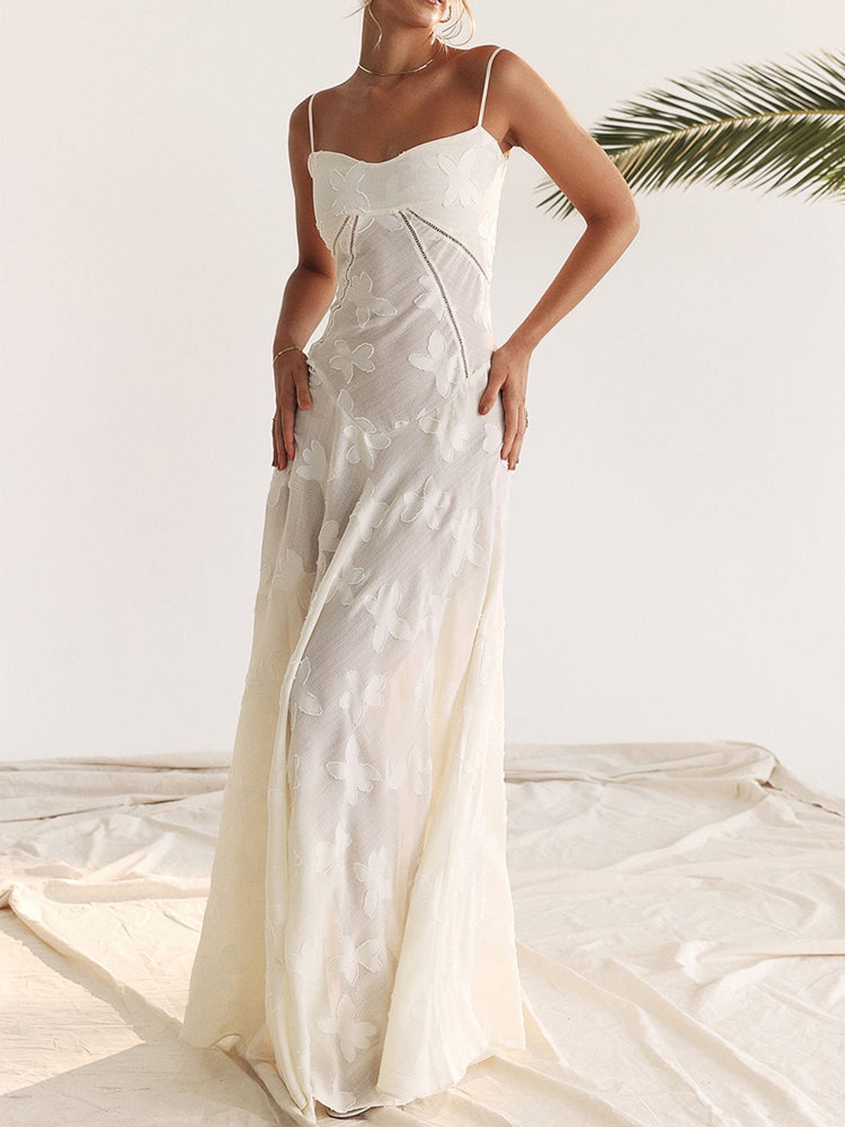 Elegant white maxi dress with lace detailing, ideal for wedding guest or summer occasion.