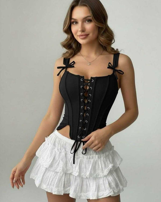 Liora Corset Top by Lauven, featuring a black lace-up design and structured silhouette, paired with a white ruffled skirt.