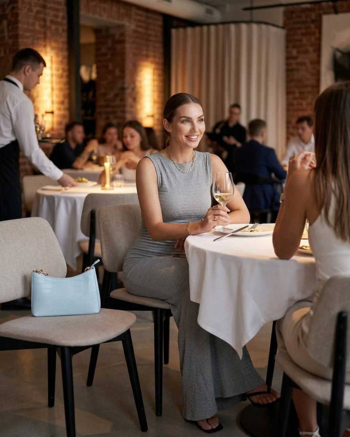 Liora Maxi Dress worn by a woman in a restaurant, showcasing its elegant style and comfort for any occasion.
