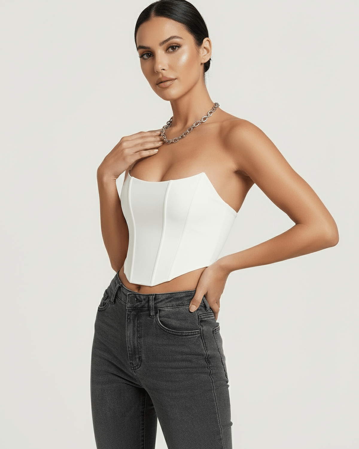 Elegant model wearing the Luna Corset Top by Lauven, showcasing its structured white velvet design.