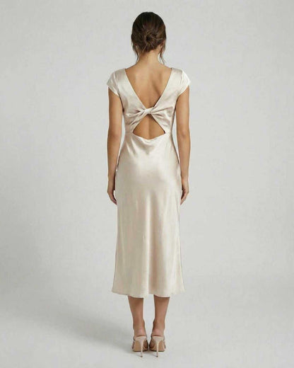 Luna Midi Dress showcasing a twisted-back design and cutout detail, crafted in luxurious satin by Lauven.