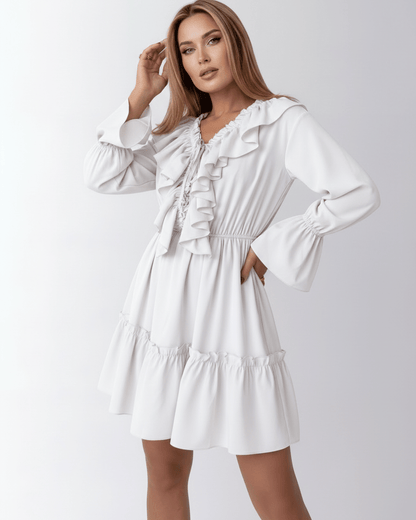Lauven Luna Mini Dress featuring ruffled V-neck, elastic waist, and bell cuffs for a feminine silhouette.