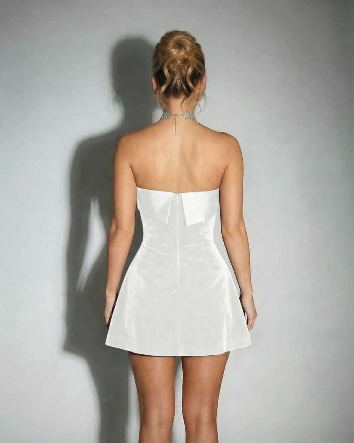 Luna Mini Dress showcasing elegant white strapless velvet design with A-line silhouette by Lauven.