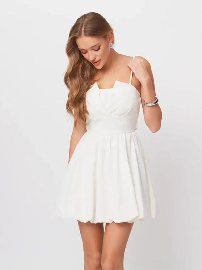 Luna Mini Dress in white with adjustable straps and A-line silhouette, perfect for summer parties or graduations.