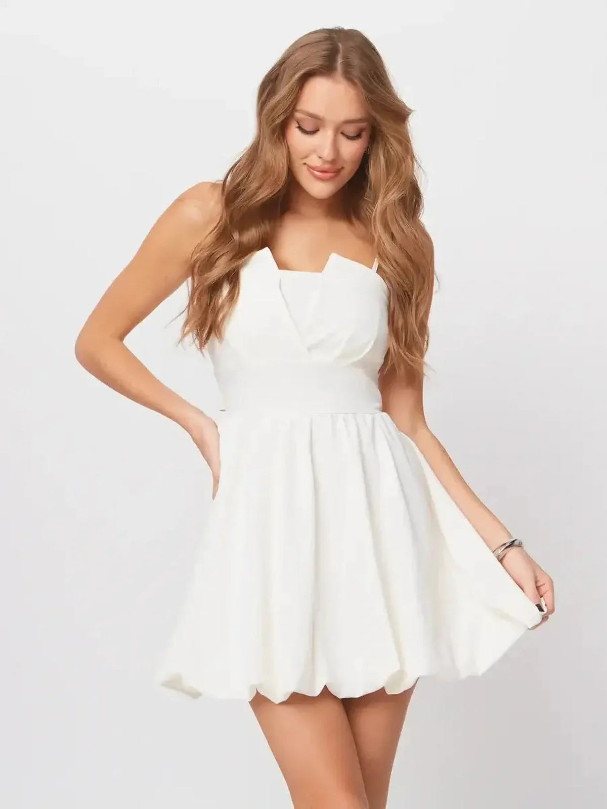 Luna Mini Dress in white, featuring adjustable straps, A-line silhouette, and elegant back bow, perfect summer and wedding guest attire.