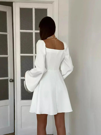 Back view of Luna Whisper white mini dress featuring a square neckline and voluminous long sleeves, perfect for weddings and formal events.