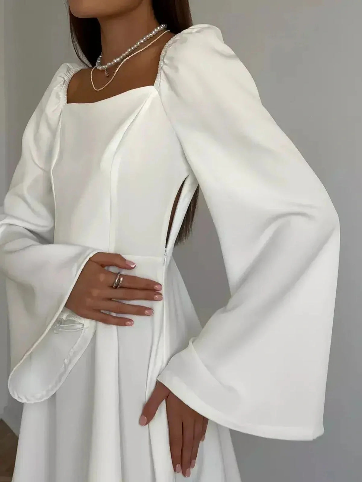 Detail of Luna Whisper mini dress featuring a square neckline, voluminous long sleeves, and a chic silhouette.