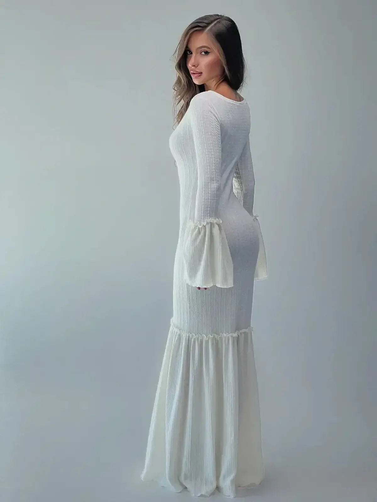 Elegant white Lustre Maxi Dress showcasing bell sleeves and a flounced hem for a graceful silhouette.