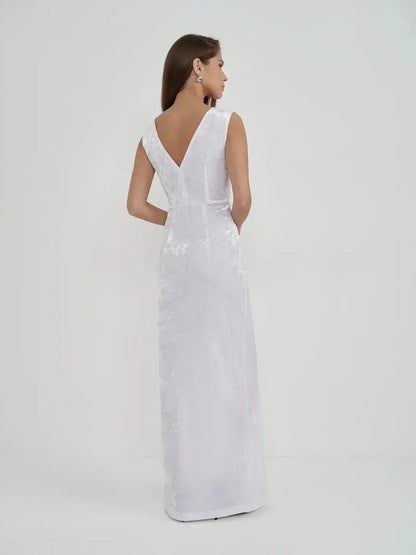 Elegant back view of the Lustre Twist Maxi Dress in white crushed velvet, showcasing its sculptural silhouette and modern design.