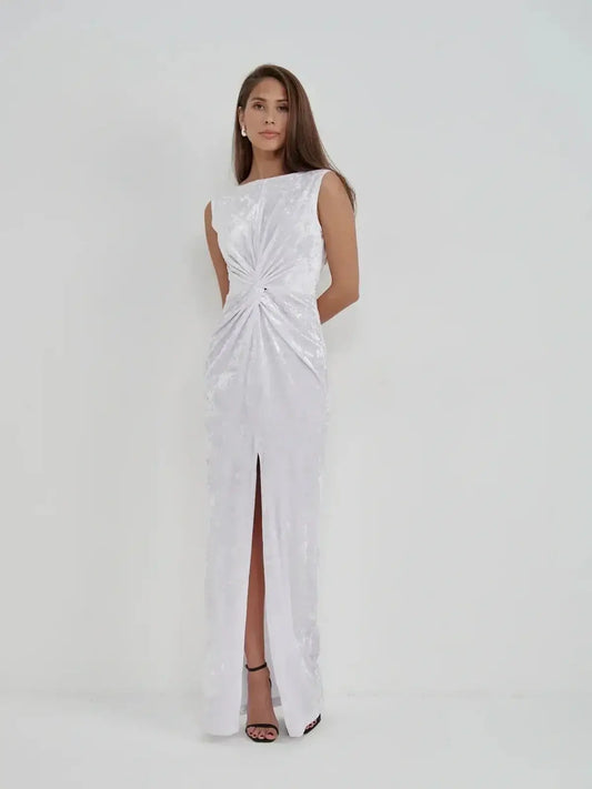 Lustre Twist Maxi Dress in white crushed velvet, featuring a twist detail and elegant slit for evening wear.