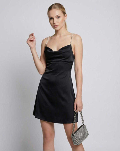 Lyra Mini Dress by Lauven with satin finish, draped neckline, and pearl strap detail, perfect for modern elegance.