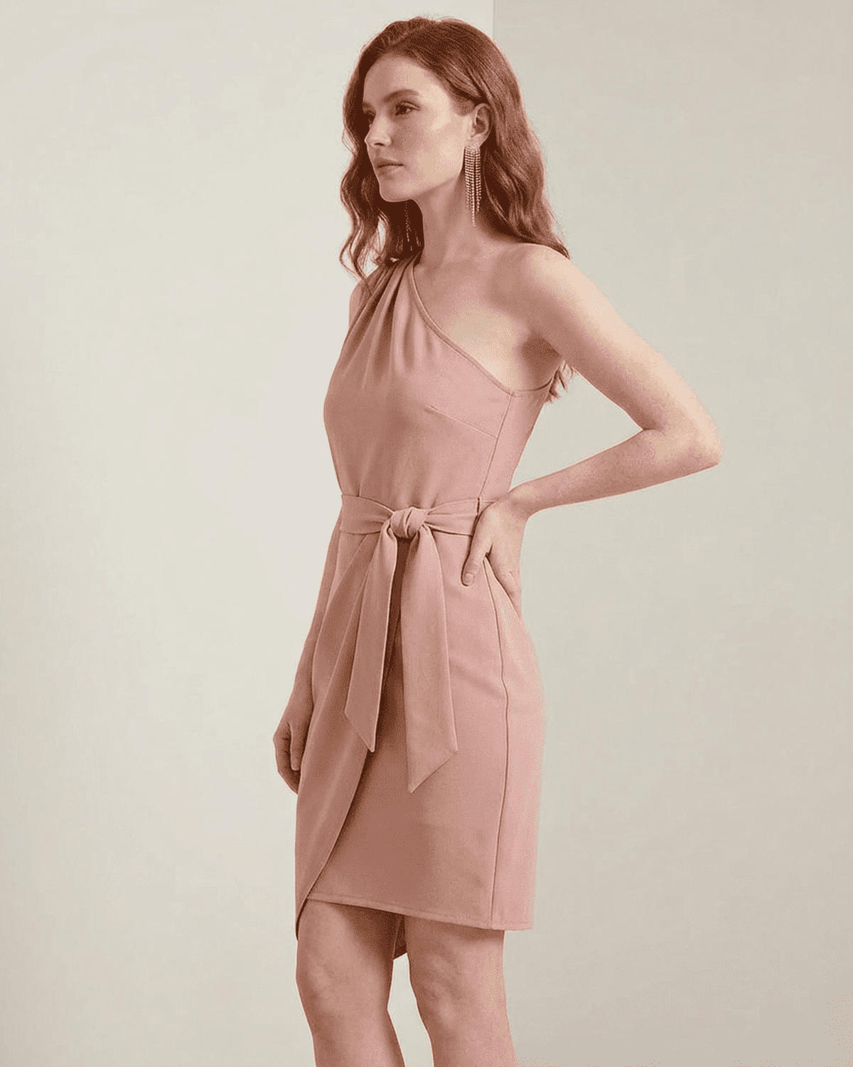 Model wearing the Lauven Lyra Mini Dress, a pink one-shoulder satin bodycon with an asymmetrical hem.