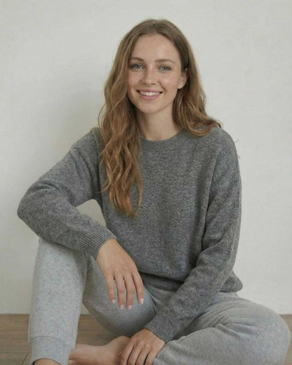 Lyra Pullover by Lauven, a soft wool knit sweater in a relaxed silhouette worn by a smiling woman.