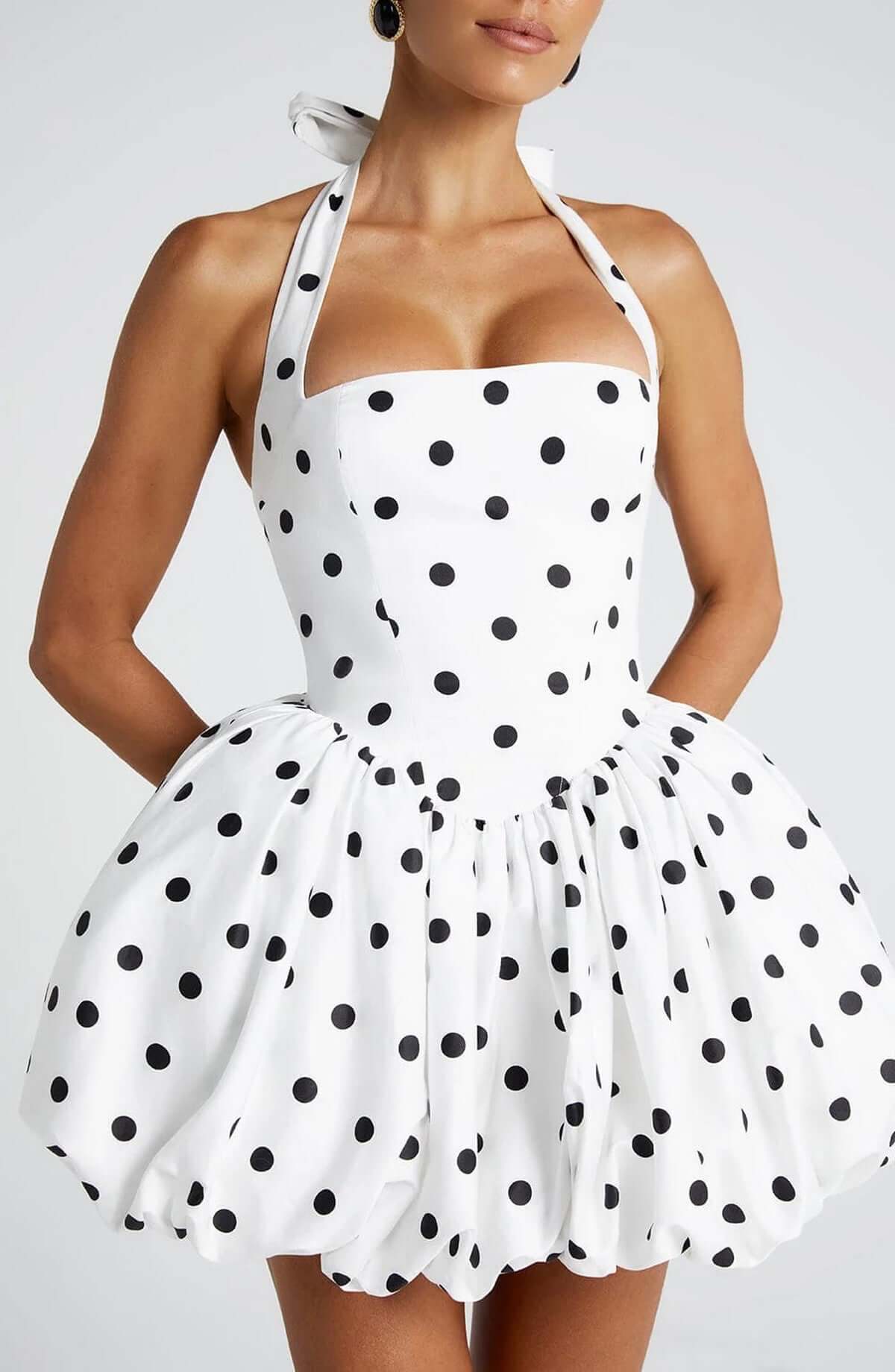 White halter mini dress with black polka dots, perfect for summer parties and casual outings.