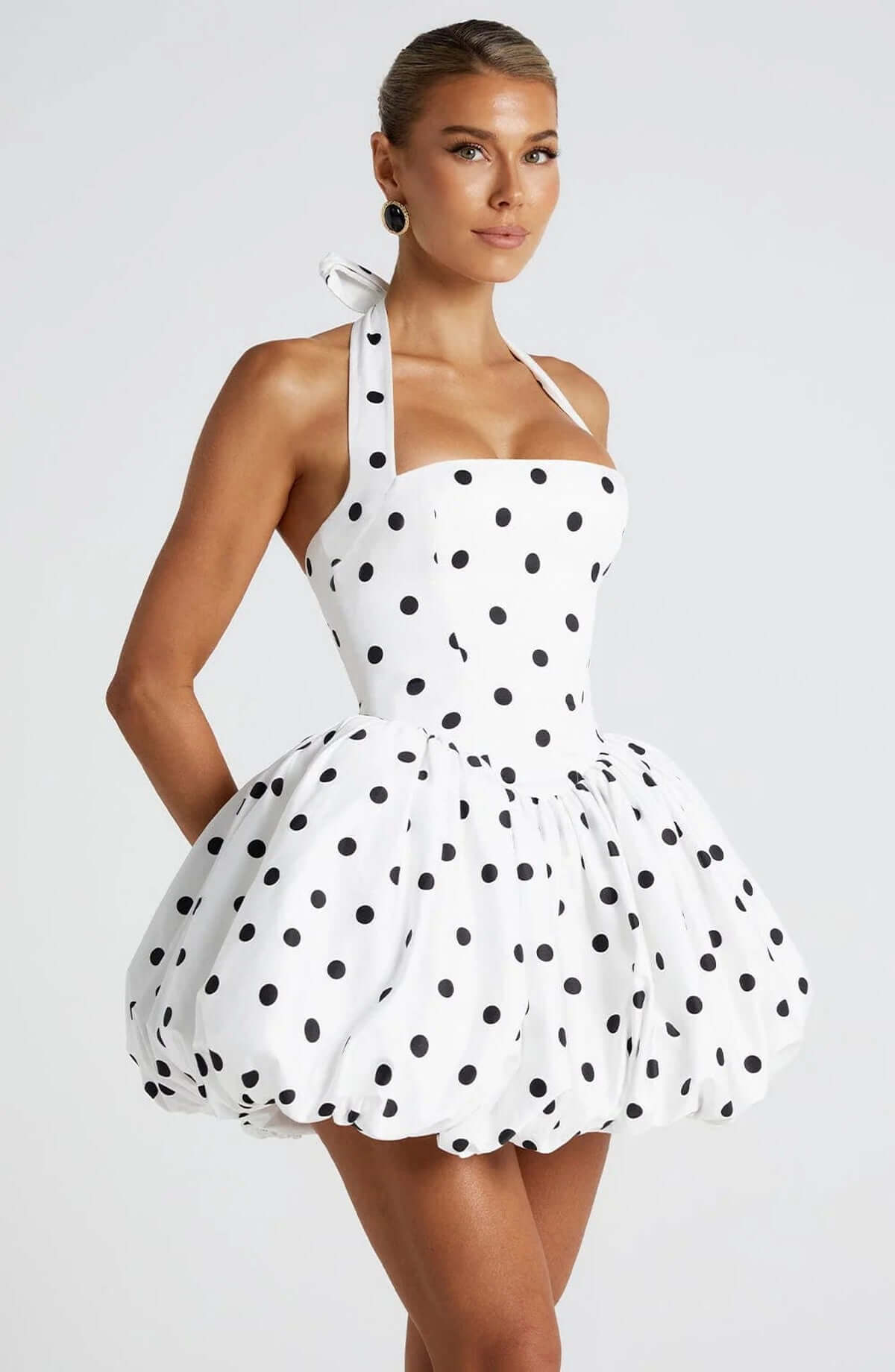 Chic Mae Mini Dress with polka dots, featuring a halter neckline and playful silhouette for summer parties.