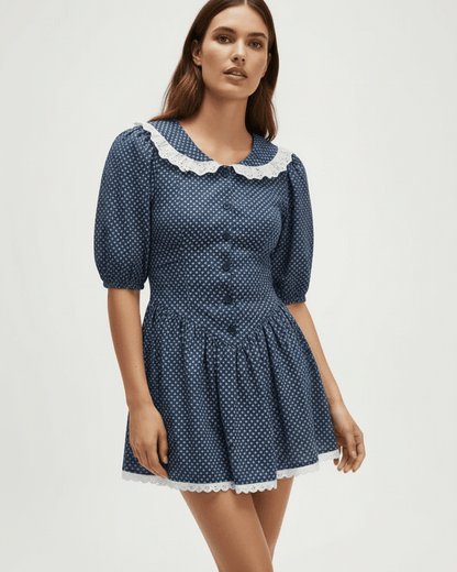 Marinette Mini Dress by Lauven features a light navy polka dot design with Peter Pan collar and puff sleeves.