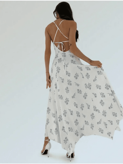 Elegant woman in a blue floral maxi dress with an open-back, showcasing breezy summer style.