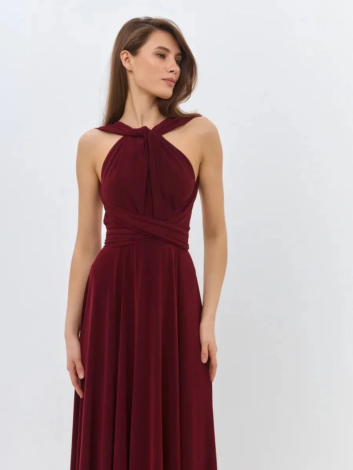 Model wearing a convertible Bordeaux Muse maxi dress showcasing elegant draping and backless design.