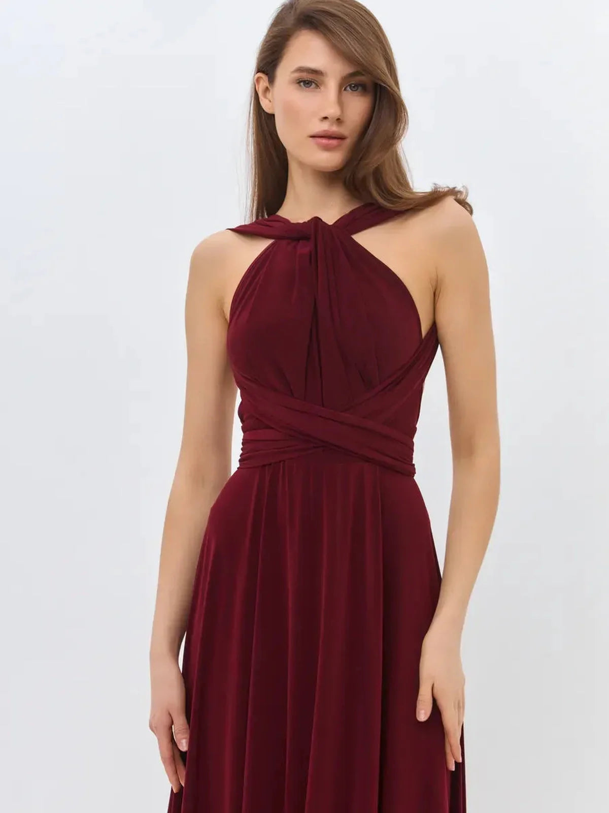 Convertible burgundy maxi dress featuring elegant draping and backless design, perfect for formal occasions.